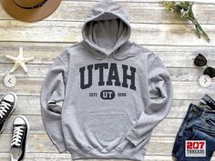 Utah Hoodie | Utah  Sweatshirt Hooded Sweater | Retro Vintage State College University Style UT Gift Shirt Native Art Print Everyone needs a cozy go-to hoodie to curl up in, so go for one that's soft, smooth, and stylish. It's the perfect choice for cooler evenings! * 50% pre-shrunk cotton, 50% polyester * Fabric weight: 8.0 oz/yd² (271.25 g/m²) * Air-jet spun yarn with a soft feel and reduced pilling * Double-lined hood with matching drawcord * Quarter-turned body to avoid crease down the middl Hawaii Hoodie, California Hoodie, New York Sweatshirt, California Sweatshirt, University Style, Distressed Sweater, Distressed Sweaters, Vintage Florida, Vintage New York