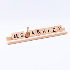 scrabble letters spelling the word ms and s on a white background