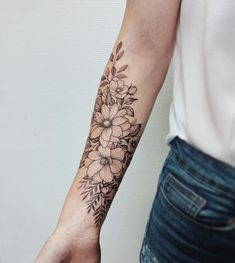 a woman's arm with a flower tattoo on the left side of her arm