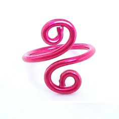 a pink ring sitting on top of a white surface