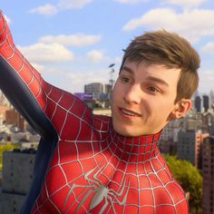 a young man in a spider - man suit poses for the camera