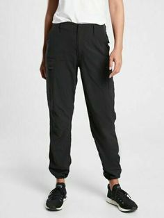 Athleta Trekkie Utility Cargo Pant #657594 BLACK (FIRST PICTURE) SIZE 10 EXCELLENT USED CONDITION (LIKE NEW) $98.00 FIT & SIZING Relaxed with room to move Sits at the natural waist Straight leg, loose fit Inseam: Regular/Plus: 30" Petite: 28" Tall: 33" PRODUCT DETAILS FOR: Hiking, climbing and exploring, on or off the trail FEEL: Sleek, lightweight Ripstop has 2-way stretch for extra mobility FAVE: Adjustable hem at the leg opening Multiple storage solutions: 2 front pockets, 2 back pockets, and Hiking Pants Women, Travel Pants, Hiking Pants, Cargo Pant, Athletic Pants, Edgy Outfits, Black Bottoms, The Trail, Tight Leggings