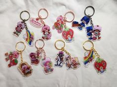 there are many key chains with cartoon characters on them