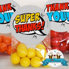 two bags filled with yellow and red candies in front of a sign that says thank you