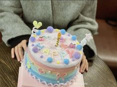 a small child is sitting in front of a birthday cake