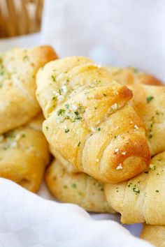 small pastries sitting in a basket on top of a table