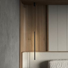 a white bed sitting next to a wooden headboard