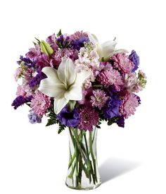 a vase filled with purple and white flowers