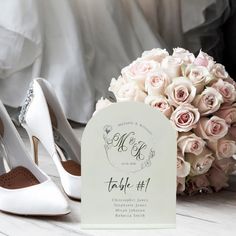 a bouquet of flowers next to a pair of white shoes and a sign with the date on it