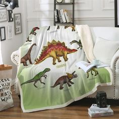 a living room with a couch covered in a dinosaur blanket