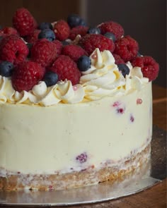 a close up of a cake with berries on top