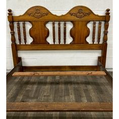 an old wooden bed frame with wood slats