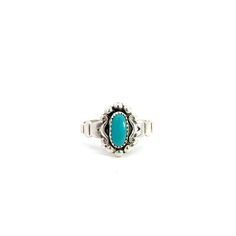 A turquoise solitaire ring. Set in the center of the ring in a bezel setting is an oval cabochon turquoise. There is a stylized scroll design around the bezel. The ring has a split style shank. This ring is a size 4 3/4.  This ring cannot be sized by our goldsmith. Stone Information Type: Turquoise Metal Content Guaranteed sterling silver Weight: 1.94 grams Measurements of Ring 7/16 inches wide at top (12mm) 1/8 inches off finger (3mm) 2.3mm wide shank at bottom Markings "Sterling" Manufacturer Classic Turquoise Ring With Oval Cabochon, Classic Oval Cabochon Turquoise Ring, Adjustable Turquoise Oval Cabochon Ring, Vintage Oval Cabochon Turquoise Ring, Vintage Oval Turquoise Cabochon Ring, Oval Turquoise Ring With Bezel Setting, Southwest Fashion, Solitaire Ring Set, Silver Turquoise Ring