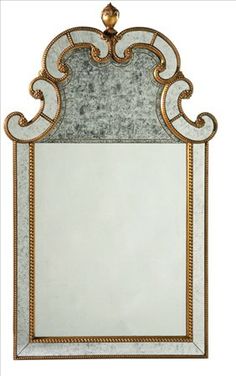 a mirror that is sitting on top of a table with a gold trimming around it