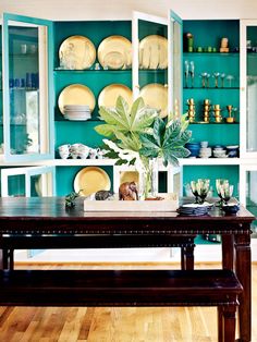 a dining room filled with lots of furniture and plates