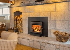 a wood burning stove sitting inside of a living room next to a chair and fire place