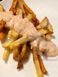 a white plate topped with french fries covered in gravy