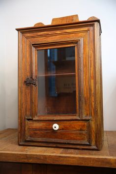 an old wooden cabinet sitting on top of a table