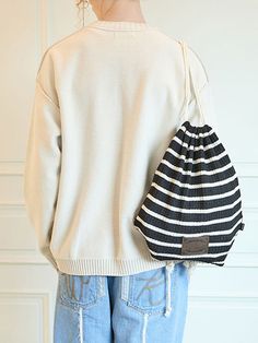 It is a drawstring bag made of textured knit fabric. The drawstring length is adjustable to fit different body shapes.- Logo label- Logo patch- Stripe pattern- Unisex item Casual Knitted Shoulder Bag, Casual Black Pouch Bucket Bag, Casual Bucket Bag, Casual Knitted Pouch Bag, Casual Black Knitted Shoulder Bag, Casual Pouch Drawstring Bag, Casual Pouch Drawstring Bag For Travel, Casual Drawstring Pouch Bag For Travel, Black Casual Drawstring Bag For Travel