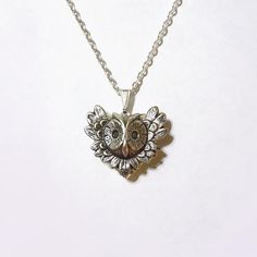 An antique silver owl charm placed on a silver plated heart locket. The locket is etched with beautiful patterns and opens easily for a spot to put in your dearest memories. It hangs on a 24 inch silver tone chain.It is packaged in a lovely little silhouette box, set on a soft piece of white cotton.••••••••••••••••••••••••••••••••••••••• ♥ • ♥ • ♥ • ♥ • ♥ • ♥ • ♥ • ♥ •••••••••••••••••••••••••••••••••••••••••© Original design by Twilight's CastleThank you for visiting!Twilight's Castle Handmade Heart-shaped Antique Silver Jewelry, Handmade Antique Silver Heart Jewelry, Antique Silver Heart Charm Jewelry Gift, Antique Silver Heart Pendant Necklace As Gift, Antique Silver Heart Charm Jewelry For Valentine's Day, Antique Silver Jewelry With Heart Charm For Valentine's Day, Valentine's Day Antique Silver Heart Charm Jewelry, Spiritual Heart Necklace As A Valentine's Day Gift, Antique Silver Heart-shaped Jewelry Gift