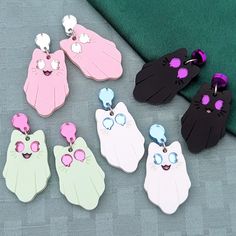 Spooky Kitty earrings are fun for any time of the year. Current colorways include Void (black with purple eyes), Light (white with light blue eyes), Spring (pastel green with pink eyes), or Blush (pink with silver eyes). They are made with mirror and matte acrylics and engraved with details. A cute accessory for any aesthetic. Get them with default studs as pictured, or if you select fishhooks, huggies/leverbacks, or clip-ons the teardrop on top will be replaced. If you would like gold-toned met Playful Pink Cat Design Jewelry, Cute Cat Design Earrings For Party, Kawaii Pink Cat Design Jewelry, Pink Cat Design Earrings With Cat Ears Shape, Matte Acrylics, Spooky Kitty, Silver Eyes, Light Blue Eyes, Laser Projects