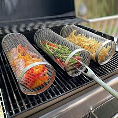 three baskets filled with food sitting on top of a grill