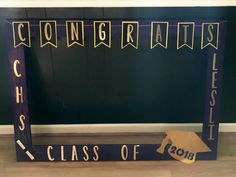 a graduation sign with congratulations written on it and a mortar cap next to it that says class of 2018