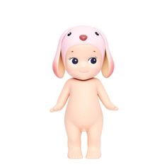 a small doll with a pink hat on it's head and ears, standing in front of a white background