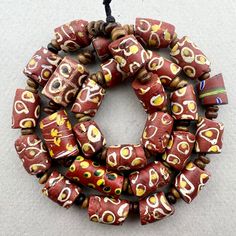 "A strand of mixed brown and white Venetian Beads traded to Africa in the late 1800's or early 1900's. In overall good condition with some chips on a few.  27 beads 19\" strand with wood spacers 10 to 11mm diameter  2mm hole on average" Brown Beaded Necklace With Colorful Oval Beads, Vintage Style Wooden Beads For Jewelry Making, Artisan Brown Spacer Beads, Brown Polished Beads For Jewelry Making, Traditional Hand-strung Brown Beads, Unique Brown Polished Beads, Brown Wooden Beads For Jewelry Making, Artisan Brown Beaded Necklaces With Oval Beads, Artisan Brown Beaded Necklace With Oval Beads