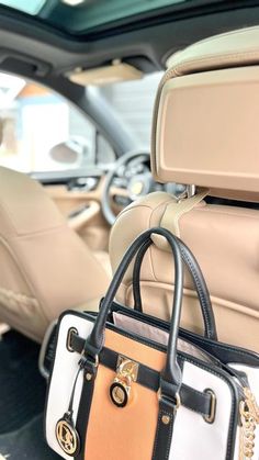 a purse sitting on the back seat of a car