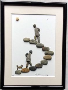 an art work with rocks and pebbles in the shape of a man climbing up a hill