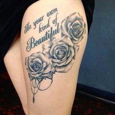 a woman's thigh with roses and the words be your own kind of beautiful