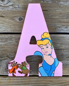 a wooden letter shaped like a princess with an image of a cartoon character on it