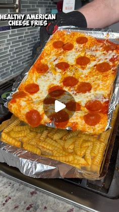 a large pizza sitting on top of a metal pan covered in cheese and pepperoni