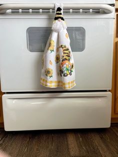 a kitchen towel hanging on an oven door