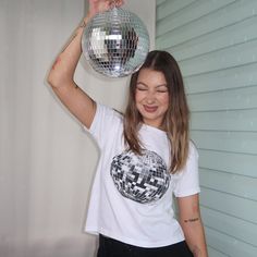 Mirror Ball Baby Tee - Revamp your wardrobe with Everlace Designs' exclusive collection of essential tees, cozy hoodies, and playful baby tees in signature prints. Shop now for vibrant, cheeky designs perfect for any casual occasion. Elevate your everyday style with Everlace. 🍒 Connect with Everlace Designs: We invite you to join our community and stay updated with our latest designs and content. Follow us on: TikTok: @everlace.designs  Instagram: @everlacedesigns Pinterest: @everlacedesigns Be White Unisex Y2k Style Tops, Unisex Y2k White Top, Unisex White Y2k Style Tops, Y2k Unisex White Top, 90s Style Short Sleeve Party Tops, Disco Style Cotton Top With Short Sleeves, Y2k Crew Neck T-shirt For Party, 90s Short Sleeve Party Tops, Disco Style White Top With Graphic Print