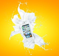 an iphone is floating in milk and splashing