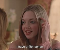 a woman with blonde hair talking to another woman in front of a mirror that says, i have a fifth sense