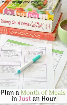 a stack of books and a cup of coffee on a table with text overlay that reads plan a month of meals in just an hour