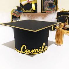 a graduation cap with the name camellla on it and tassels around it