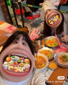 two people eating food at a table with chopsticks in front of their mouths