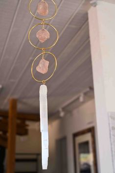 a wind chime with three crystals hanging from it's sides and two circles around it