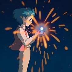 a person holding a light in their hand with fireworks coming out of the sky behind them