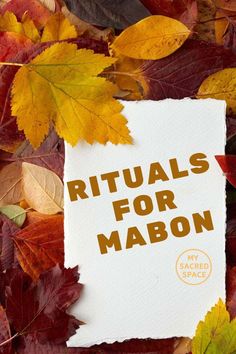 a piece of paper with the words rituals for mabon on it surrounded by autumn leaves