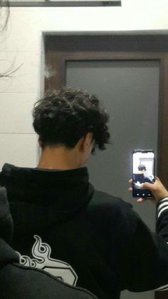 a man taking a selfie in front of a mirror