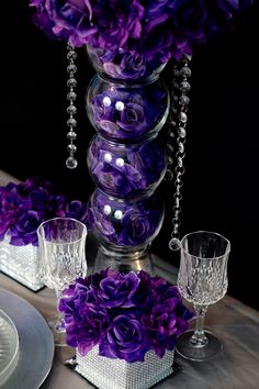 purple flowers and crystal vases on a table