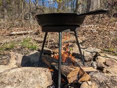 a grill sitting on top of a pile of rocks