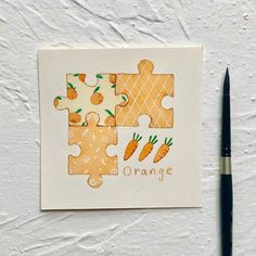 a piece of puzzle with carrots on it and the word orange painted on it