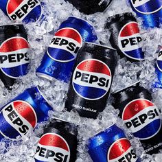 several cans of pepsi are sitting in ice