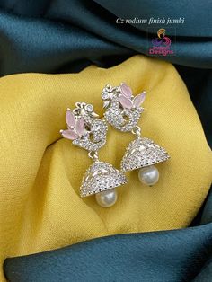 "Priced only $19.99, These super cute Gold plated Jhumka earrings will make you look elegant and classy, even when you are in a rush. They are perfect accessory for casual wear, but also any great addition to any formal outfit. Shop now!\"	is_active	20473503	Apparel & Accessories > Jewelry > Earrings	https://www.etsy.com/listing/1342667207/small-cute-gold-jhumka-american-diamond	jewelry > earrings > dangle_earrings > jhumkas	https://i.etsystatic.com/20473503/r/il/75a54d/4376913923/il_fullxfull.4 Festive Silver Jhumkas With Elegant Design, Elegant American Diamond Jhumkas, American Diamond Jhumkas For Celebration, Celebration American Diamond Jhumkas, Diwali American Diamond Jhumkas, Elegant Dual-tone Jhumkas For Diwali, American Diamond Jhumkas Drop Earrings For Gift, American Diamond Drop Jhumkas For Gifts, American Diamond Drop Earrings Jhumkas For Gift